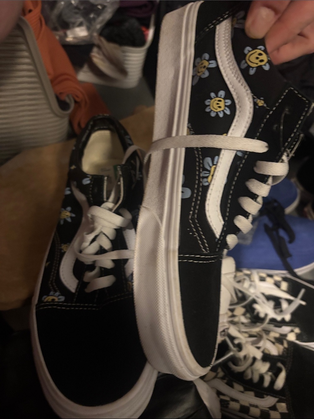Vans black suede low tops with smiling daisies